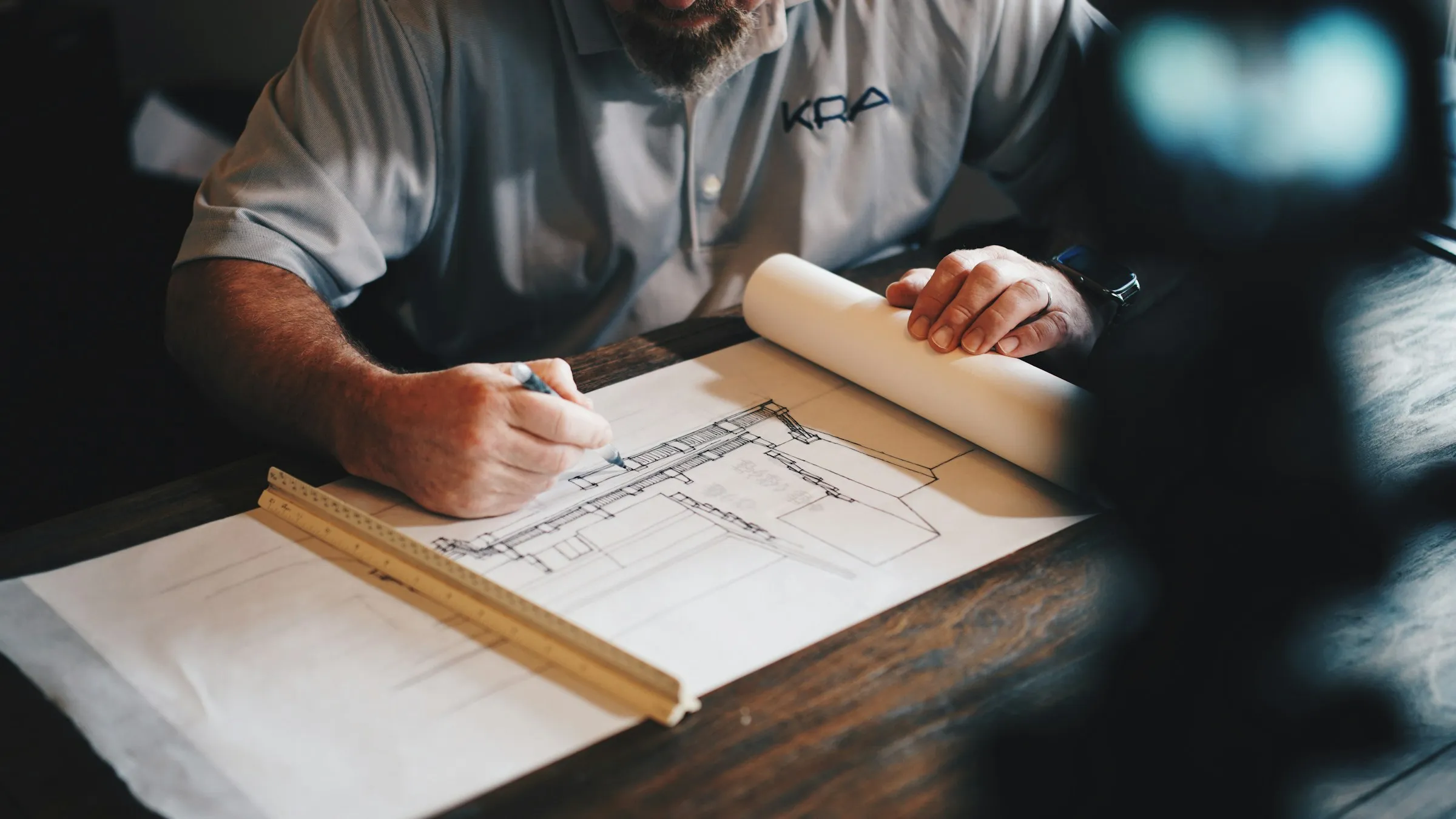 Reviewing architectural plans at a desk